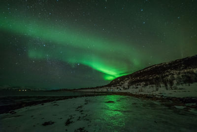 Scenic view of landscape against sky at night