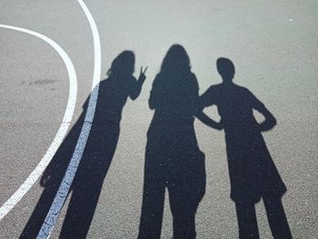 Shadow of people on road