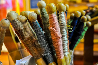 Lose-up of colorful threads on wood for sale at market