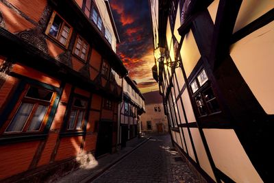 Narrow street amidst buildings against sky