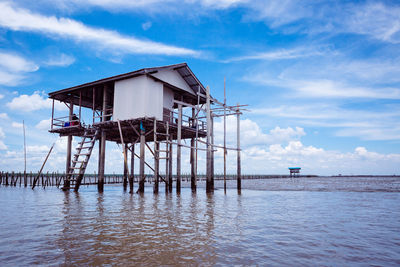 Lifeguard hut by sea against sky