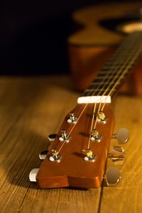 Close-up of acoustic guitar on table