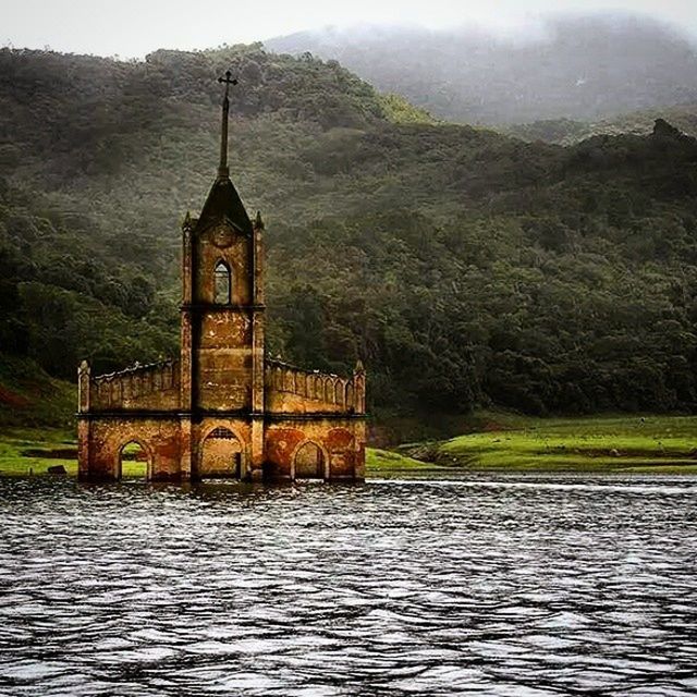 water, waterfront, architecture, built structure, building exterior, tree, lake, religion, mountain, river, church, tranquility, place of worship, tranquil scene, nature, spirituality, scenics, reflection, sky