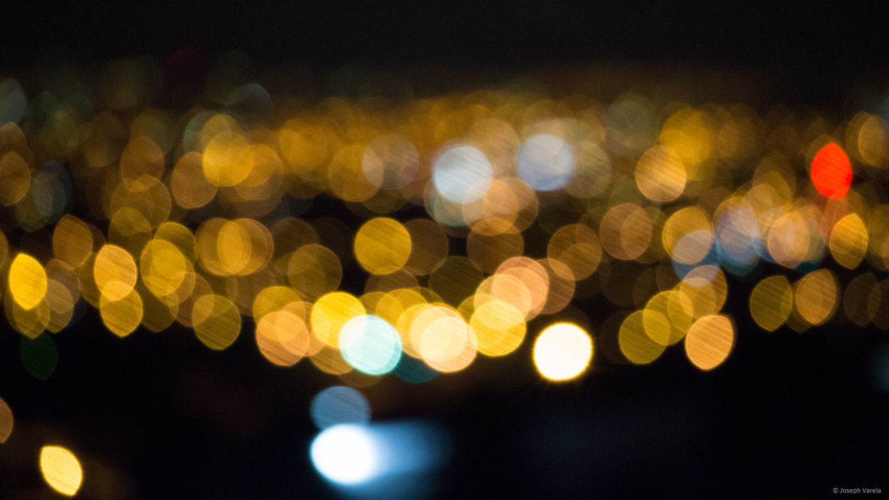 DEFOCUSED LIGHTS IN CITY AT NIGHT