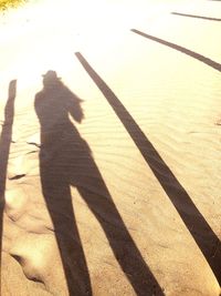 Shadow of person on sand at beach