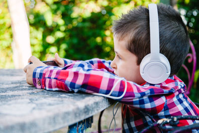 Cute boy listening music on headphones