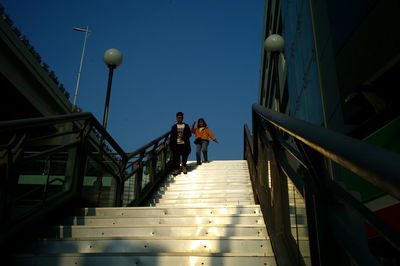 Low angle view of people walking on staircase