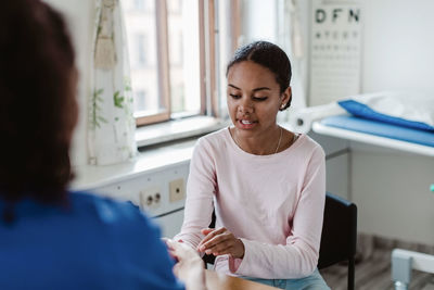 Female healthcare worker examining patient in medical clinic