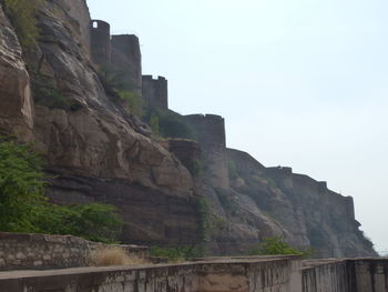 Low angle view of rock formation against sky