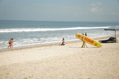 People on beach against sky