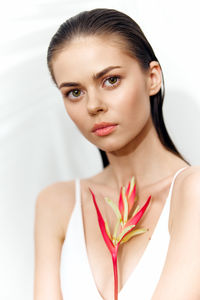 Portrait of young woman against white background