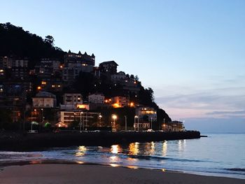 Illuminated buildings at waterfront