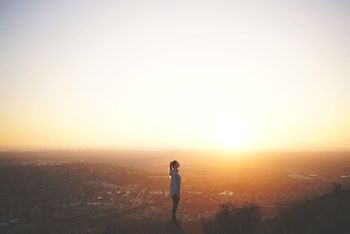 Woman on mountain at sunset