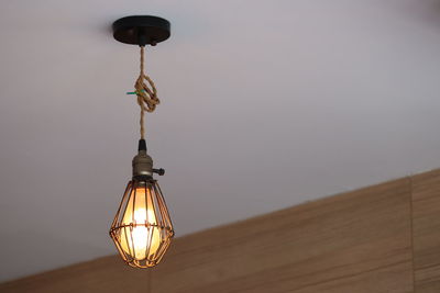 Low angle view of illuminated lamp against sky