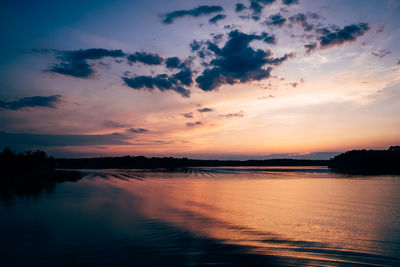 Scenic view of lake against romantic sky at sunset