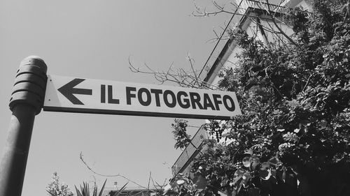 Low angle view of road sign against sky