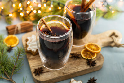 Hot freshly brewed homemade mulled wine with orange slices, cinnamon stick and anise.