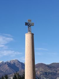Low angle view of statue against blue sky