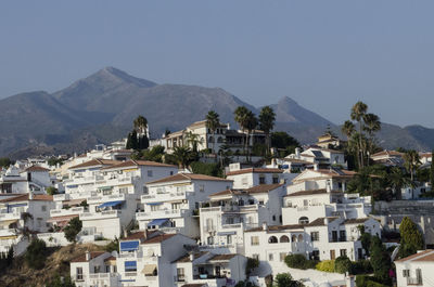 Buildings in city against clear sky