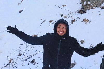 Young woman standing on snow covered landscape during winter