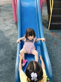 High angle view of women on slide at playground