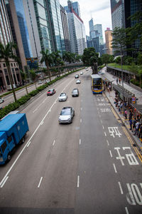 Vehicles on road amidst buildings in city