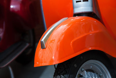 Close-up of scooters parked at shop