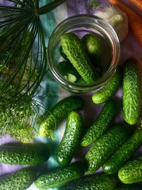 Directly above shot of cucumbers in jar and table