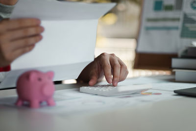 Midsection of woman working on table