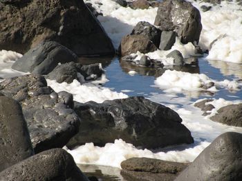 High angle view of rocks at sea shore