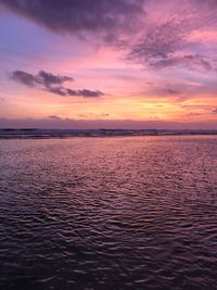 Scenic view of sea against romantic sky at sunset