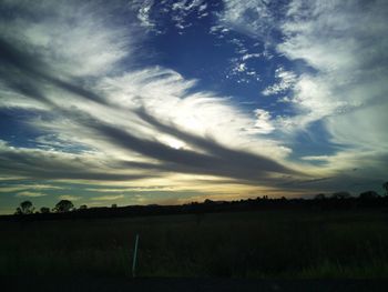 Scenic view of field against sky during sunset