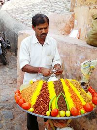 High angle view of man preparing food at market stall