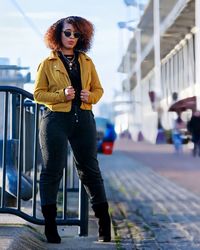 Portrait of young woman standing in city