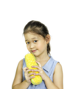 Portrait of girl holding ice cream against white background