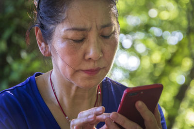 Portrait of woman using smart phone outdoors