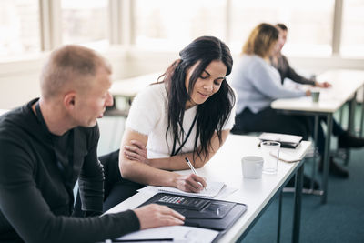 Adults working together in class