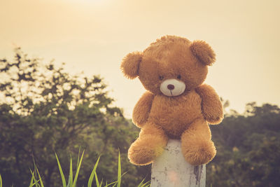 Close-up of stuffed toy against sky