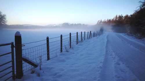 Snow covered landscape against sky