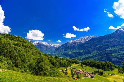 Scenic view of mountains against blue sky