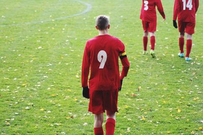 Rear view of boys on grass