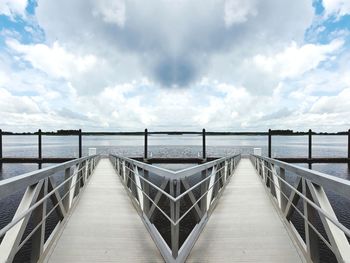 View of pier on sea against cloudy sky