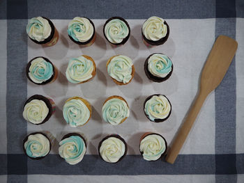 Directly above shot of cupcakes arranged on fabric
