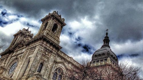 Low angle view of church against cloudy sky