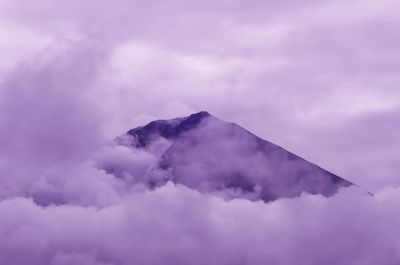 Scenic view of mountains against cloudy sky