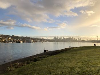 Scenic view of river against sky in city