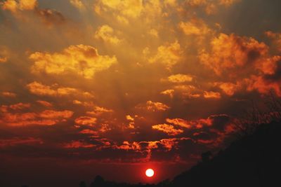 Low angle view of dramatic sky during sunset