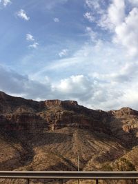 Scenic view of mountains against cloudy sky