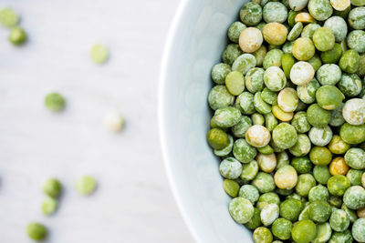 High angle view of green pea in bowl on table