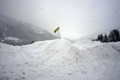 Bus stop traffic sign in europe, green and yellow sign covered in snow in winter